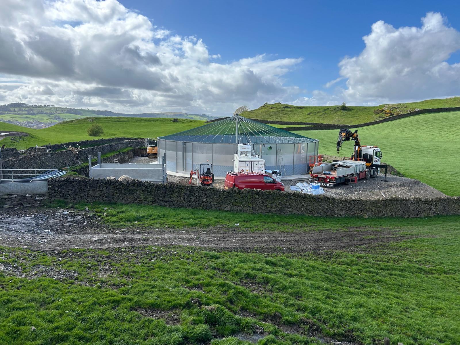 A completed Charlie Bell Building AD installation seen from above, set within dry stone walls on a working farm